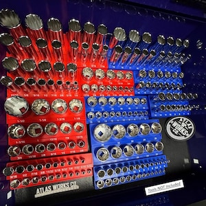 May include: Organized socket set in red and blue trays. The sockets are arranged by size, with measurements in inches. The set includes various sizes, from small to large, and is labeled with "ATLAS WORKS CO." text. "Tools NOT Included" is also visible.