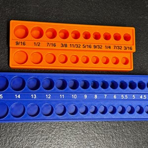 May include: Two plastic orange and blue hole gauge tools. The orange tool has fractional inch measurements from 3/16 to 9/16. The blue tool has millimeter measurements from 4 to 15. Each tool has two rows of holes.