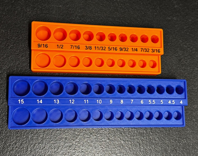 May include: Two plastic orange and blue hole gauge tools. The orange tool has fractional inch measurements from 3/16 to 9/16. The blue tool has millimeter measurements from 4 to 15. Each tool has two rows of holes.