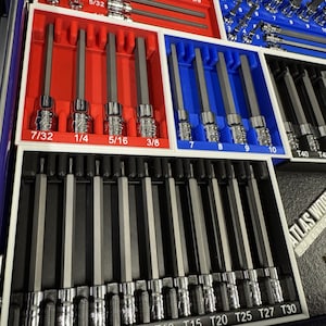 May include: A set of hex bit sockets and other sockets, organized in red, blue, and black trays. The sizes are labeled in inches, including 7/32, 1/4, 5/16, and 3/8. The set includes various sizes for different applications.