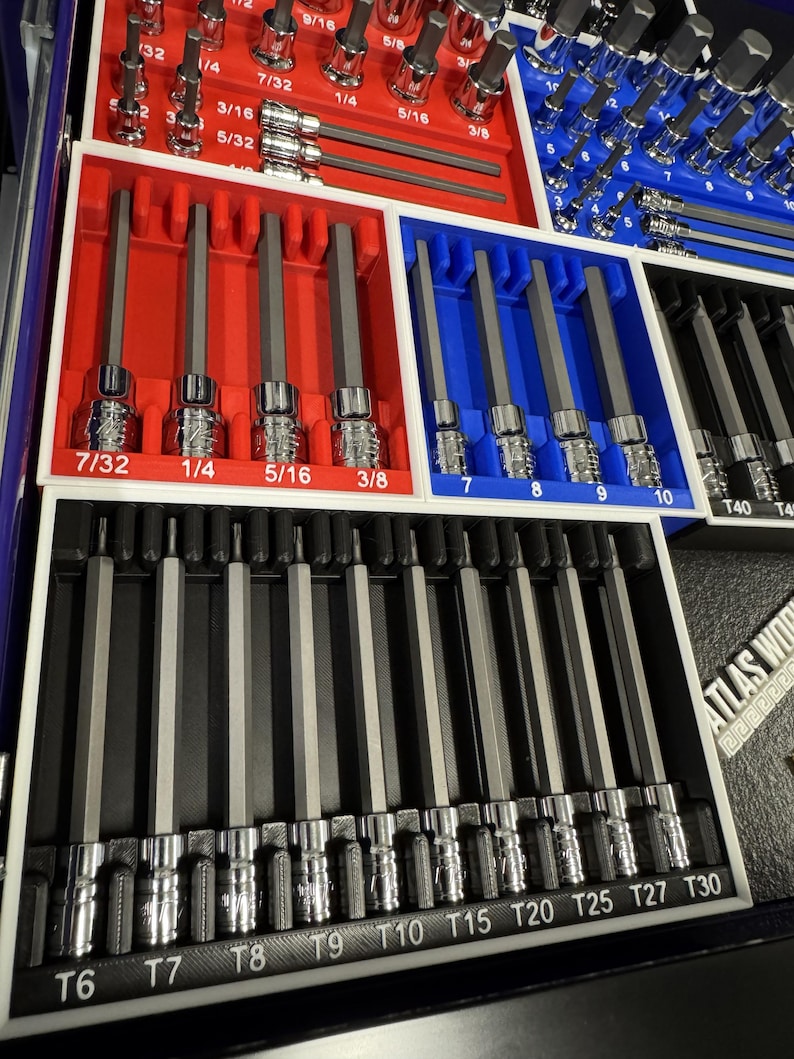 May include: A set of hex bit sockets and other sockets, organized in red, blue, and black trays. The sizes are labeled in inches, including 7/32, 1/4, 5/16, and 3/8. The set includes various sizes for different applications.