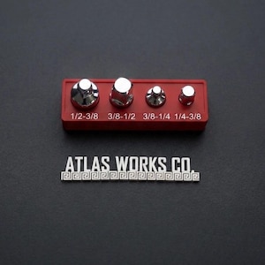 May include: A set of four chrome lug nuts in a red holder, with sizes 1/2-3/8, 3/8-1/2, 3/8-1/4, and 1/4-3/8. The text "ATLAS WORKS CO." is below the holder on a dark background.