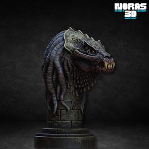 May include: A detailed sculpture of a creature's head with a menacing expression, featuring sharp teeth and intricate textures. The head is mounted on a stone pillar, with the "NORAS 3D" logo in the top right corner. The color palette includes shades of gray, brown, and beige.