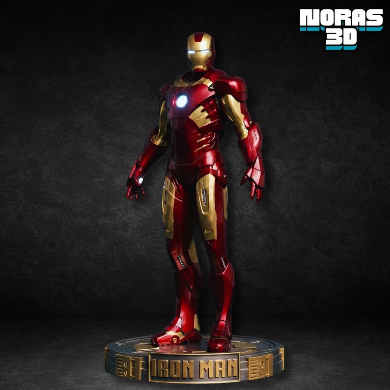May include: A detailed figurine of Iron Man in a standing pose. The figure is predominantly red and gold, with a glowing blue light in the chest and eyes. The base reads "Iron Man" and "NORAS 3D".
