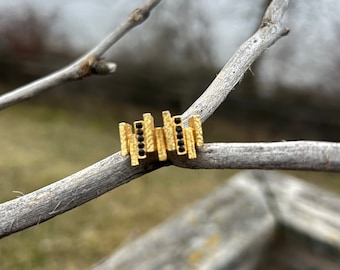 Ring, Chunky, gold with black stones, textured staggered