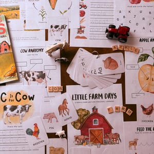 May include: A collection of educational farm-themed materials for preschool learning. Includes flashcards, worksheets, and wooden letter blocks spelling "FARM" and "COW". Features illustrations of farm animals, crops, and a red barn.