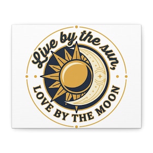 May include: A canvas print featuring a circular design with the text "Live by the sun, love by the moon." The design includes a sun and crescent moon in gold and navy blue against a white background.