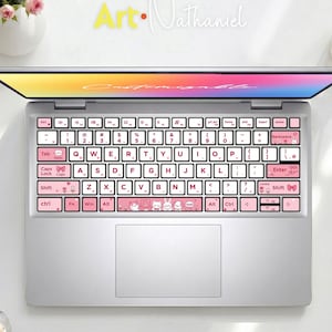 May include: A silver laptop featuring a pink keyboard cover with white keys, decorated with small animal illustrations, bows, and flowers. The screen displays a colourful gradient background with the text "Customizable" in script font.