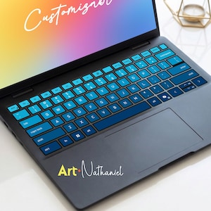 May include: A laptop with a blue and black keyboard. The keys are light blue with white lettering. The screen displays a colorful gradient. The text "Customiz" is visible on the screen. The text "Art Nathaniel" is written on the laptop.