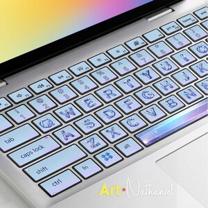 May include: A laptop keyboard cover featuring a light blue gradient background with a sparkling, crystal-like texture on each letter and number key. The design includes a shimmering space-themed spacebar and small decorative star accents.