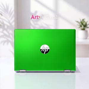 May include: A bright lime green laptop skin applied to the lid of an HP laptop. The skin features a smooth, solid color finish that covers the entire surface, with a circular cutout in the center revealing the silver and black HP logo.