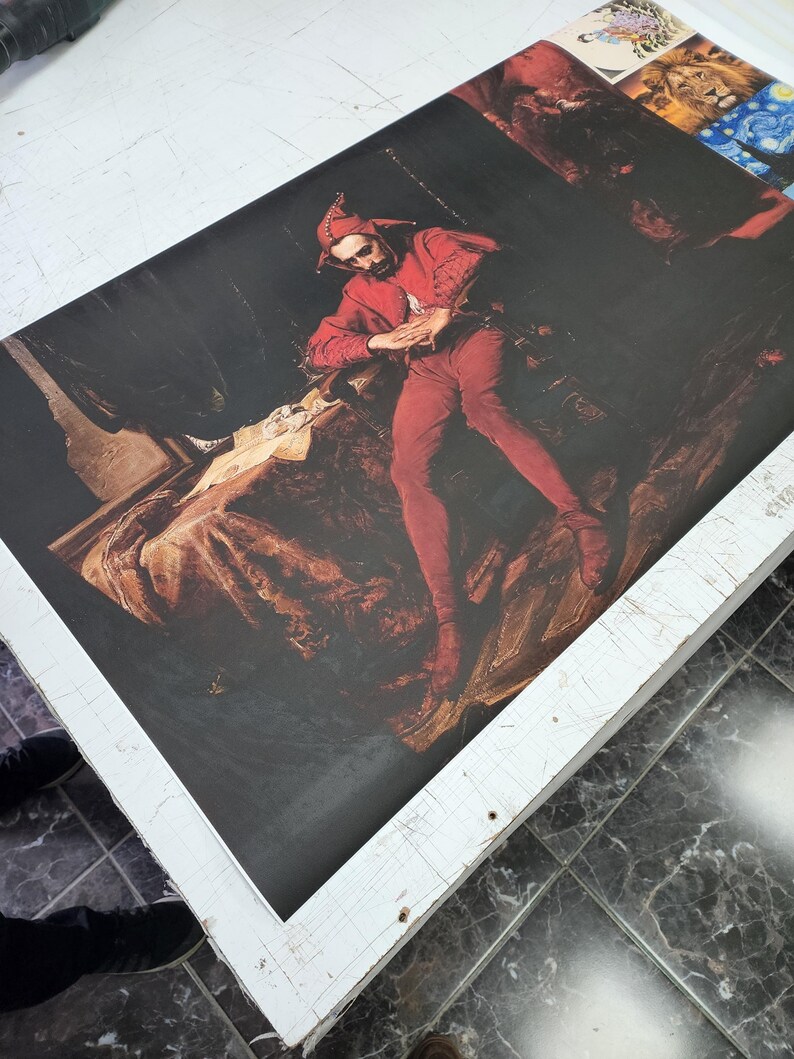 May include: A rectangular canvas print featuring a reproduction of Jan Matejko's Stańczyk painting. The artwork depicts a jester in a red costume sitting in a dark, somber room with a letter on a table. Additional small art prints are visible at the top.