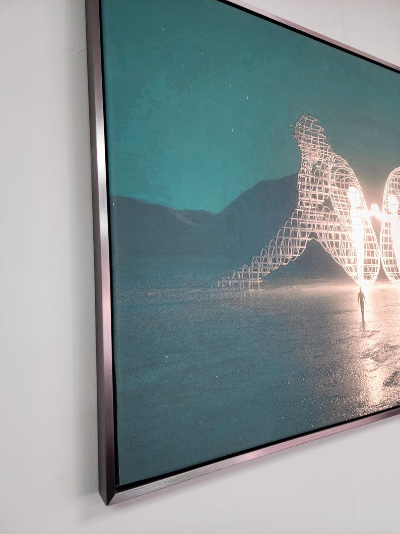 May include: A rectangular wall art piece featuring a teal-toned landscape with a large, glowing, wireframe sculpture of two figures sitting back-to-back. The artwork is encased in a thin, metallic frame with a dark, brushed finish.