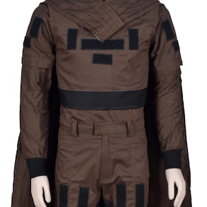 May include: Brown costume with a high collar, cape, and black accents. The outfit includes a jacket with black patches, matching pants, and black cuffs. The costume is displayed on a mannequin.