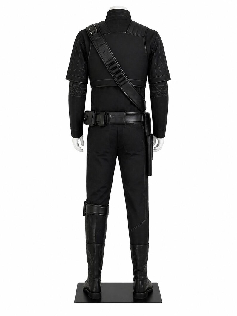 May include: A black costume displayed on a mannequin. The outfit includes a short-sleeved top, pants, boots, a belt with pouches, and a shoulder strap. The costume has quilted detailing on the shoulders and sleeves.