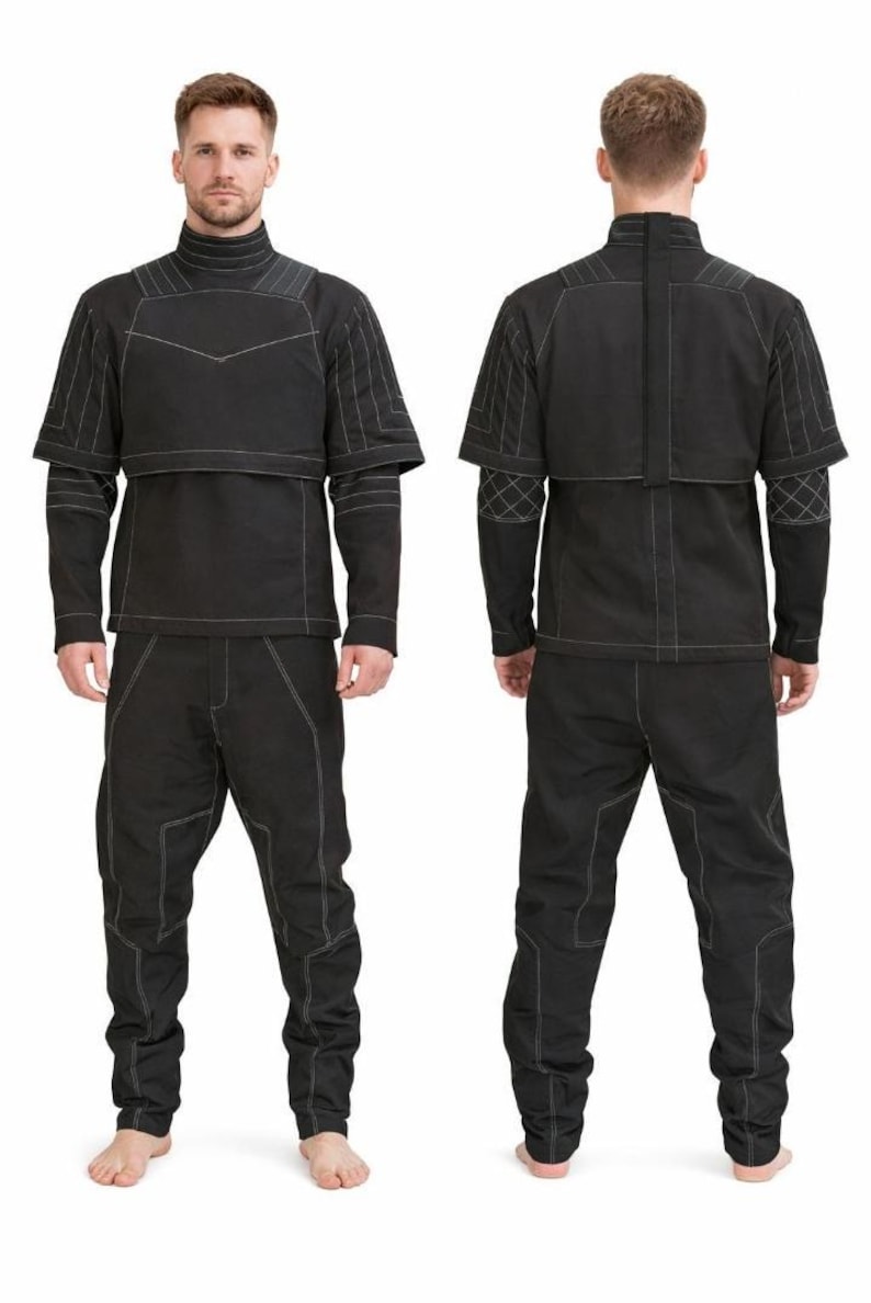 May include: A black outfit comprising a long-sleeved top and trousers. The top features a high collar and a cape-like overlay, with white stitching details. The trousers have matching stitching. The outfit is shown from the front and back.