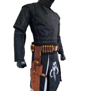 May include: Black costume with white stitching, featuring a high collar and a belt with gold-colored details. A brown holster is attached to the belt, and a white emblem is visible on the lower garment. The costume is designed for cosplay or themed events.