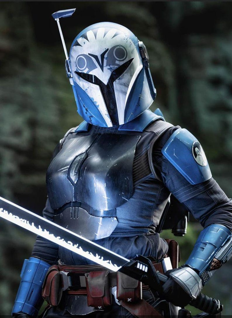 May include: A detailed image of a Mandalorian warrior in full armor. The helmet is blue and white, with a distinctive visor and antenna. The armor is a mix of blue and black, and the warrior holds a glowing sword.