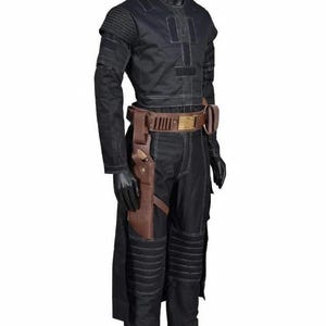 May include: Black costume with white stitching, featuring a long-sleeved top, pants, and a brown leather belt with a holster. The outfit is displayed on a mannequin, showcasing a futuristic or sci-fi aesthetic. The costume includes padded details on the shoulders and knees.