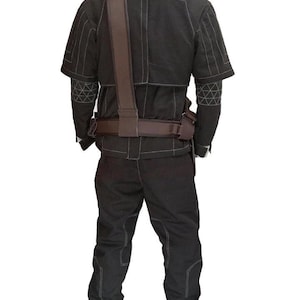 May include: Black tactical outfit with white stitching details. The outfit includes a jacket with short sleeves, pants, and a brown belt and shoulder strap. The jacket has geometric patterns on the sleeves. The outfit is designed for a specific purpose.