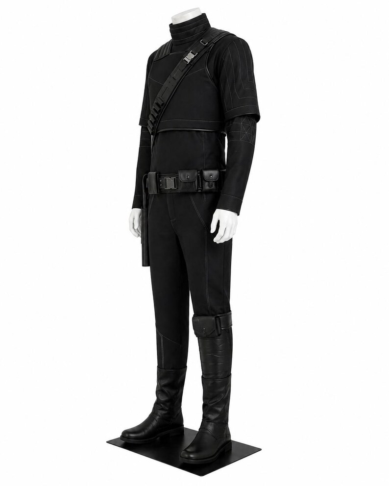 May include: A black costume with a high collar, shoulder armor, and a utility belt. The outfit includes a long-sleeved shirt, pants, and knee-high boots. The costume is displayed on a mannequin against a white background.