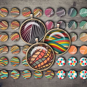 May include: Assortment of colorful round glass cabochons with various geometric and abstract patterns. The cabochons are arranged in a grid pattern on a wooden surface.