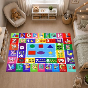May include: A rectangular educational area rug featuring a colorful border of the alphabet from A to Z, each letter paired with a corresponding illustration and word. The center displays numbers one through ten and various geometric shapes.