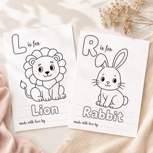 May include: Two white coloring pages featuring black line art. The left page shows a lion with the text L is for Lion and made with love by. The right page shows a rabbit with the text R is for Rabbit and made with love by. Both pages include lines for writing.