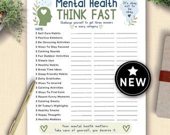 May include: A white Mental Health Think Fast worksheet with prompts for self-care and well-being. The design includes green accents, a heart-shaped logo, and the text "It's okay not to be okay." A gold pen rests on the side.