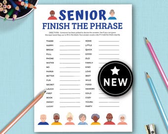 May include: A white game sheet titled "SENIOR FINISH THE PHRASE" with fill-in-the-blank prompts. A black circle with a white star and the word "NEW" is on the right. Colored pencils and a pencil sharpener are in the background.