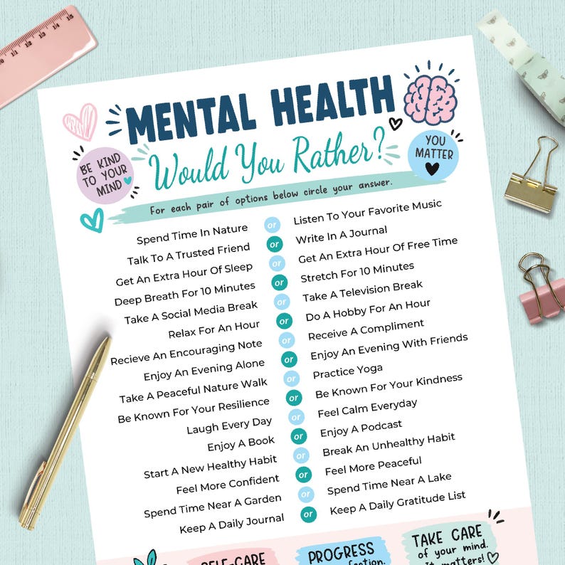 May include: A white paper sheet titled Mental Health Would You Rather with blue and pink text and illustrations. It lists pairs of self-care activities separated by or circles. A gold pen, a pink ruler, and two metal binder clips are visible.