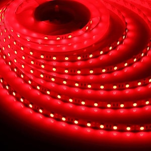 May include: A coiled strip of red LED lights, emitting a bright, warm glow. The lights are closely spaced along a flexible strip, creating a continuous line of illumination. The image is a close-up, highlighting the individual lights and the overall vibrant color.