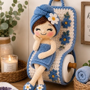 May include: A handmade crochet doll with a blue towel on its head and a matching wrap. The doll is holding a crochet toilet paper holder with blue flower accents. The holder is attached to a wooden wall mount. The doll is wearing blue shoes with white flower accents.