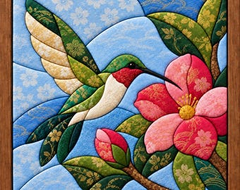 May include: A square wall art piece featuring a fabric-textured mosaic of a hummingbird with a red throat and green wings hovering near a large pink flower and a closed bud, all set against a light blue background with white cherry blossom patterns.