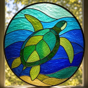 May include: A circular stained glass panel featuring a sea turtle swimming through ocean waves. The turtle is rendered in shades of green, while the surrounding water consists of textured blue and teal glass pieces with a sandy bottom.