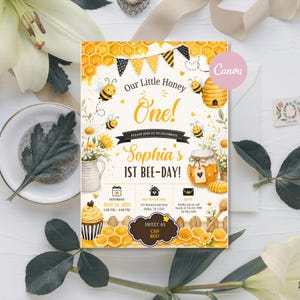 May include: A birthday invitation card featuring a honeycomb pattern, bees, a beehive, a jar of honey, and a cupcake. The text reads Our Little Honey One! Sophia's 1ST BEE-DAY! with event details for May 31, 2025, at The Honey Hive in Dallas, TX.