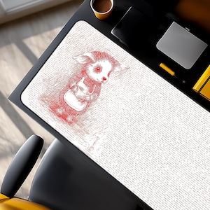 May include: A rectangular white mouse mat featuring a red illustration of a small animal in an apron, holding a cup. The mouse mat is on a black desk, with a coffee cup and other office items visible in the background.