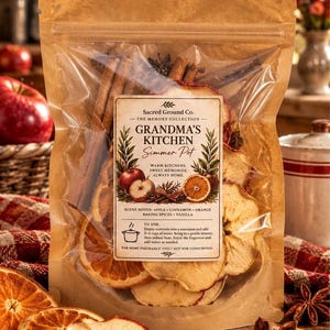 May include: A brown paper pouch containing dried apple slices, cinnamon sticks, and star anise. The label reads: Sacred Ground Co. THE MEMORY COLLECTION GRANDMA'S KITCHEN Simmer Pot. WARM KITCHENS, SWEET MEMORIES, ALWAYS HOME. SCENT NOTES: APPLE, CINNAMON, ORANGE, BAKING SPICES, VANILLA.