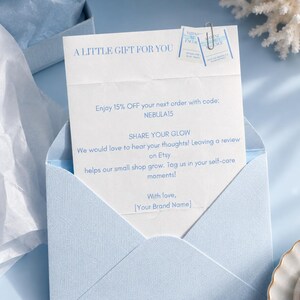 May include: A light blue envelope containing a white card with the text A LITTLE GIFT FOR YOU, a 15% discount code NEBULA15, and a request to share a review on Etsy. Two small square product labels are attached to the top with a silver paperclip.
