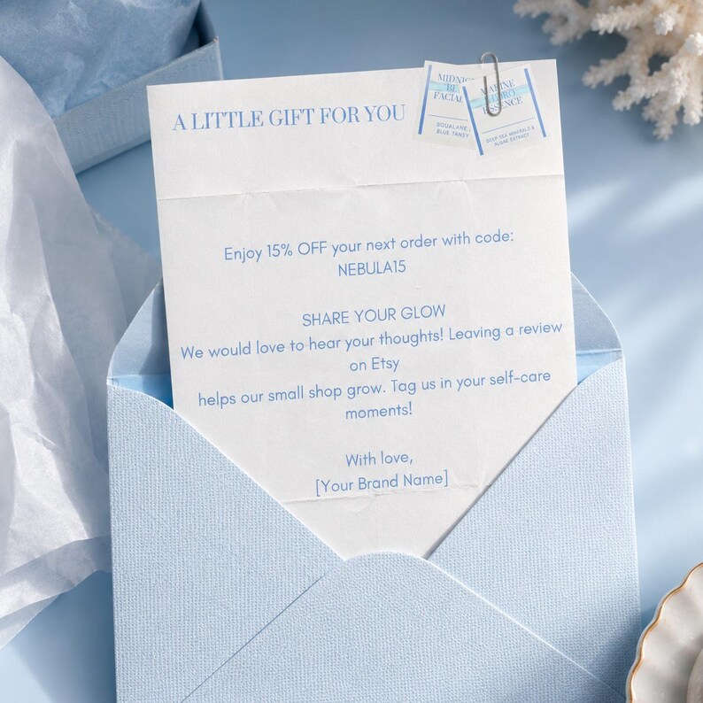May include: A light blue envelope containing a white card with the text A LITTLE GIFT FOR YOU, a 15% discount code NEBULA15, and a request to share a review on Etsy. Two small square product labels are attached to the top with a silver paperclip.
