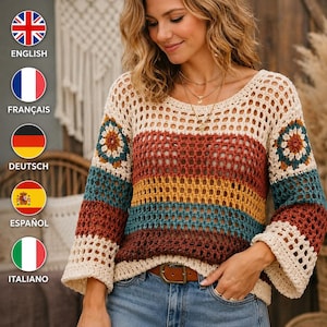 May include: A crochet sweater with a scoop neck and long sleeves. The sweater features a cream-colored base with horizontal stripes in shades of red, yellow, and teal. The sleeves have a flared design. The sweater is paired with blue jeans and a brown belt.