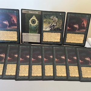 May include: A collection of ten trading cards arranged in two rows. The top row features two Rat Colony cards flanking a Command Zone card. The bottom row contains seven identical Rat Colony cards. Each card displays dark artwork, text, and borders.