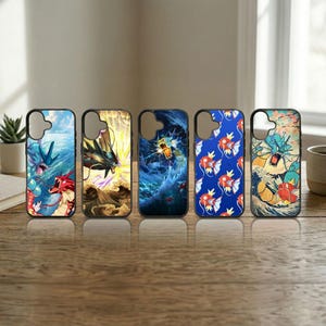 May include: Five phone cases with black borders, each featuring a different colorful design. The designs include images of sea creatures and waves in shades of blue, red, yellow, and orange. The cases are displayed on a wooden surface.