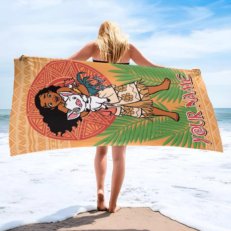 May include: A rectangular beach towel featuring a tan background with a large orange circular pattern, green palm leaves, and a cartoon illustration of a character with long dark hair holding a small pig and a chicken, with the text YOUR NAME.