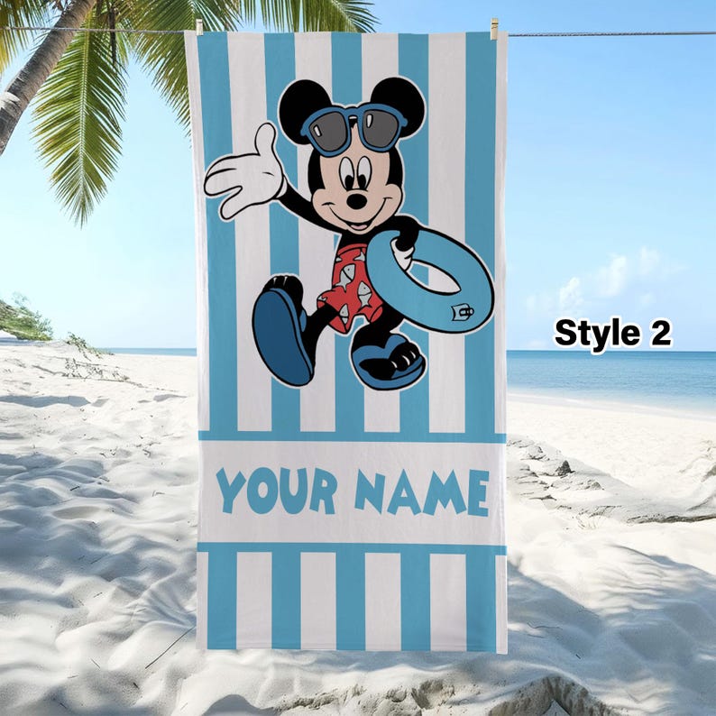 May include: A rectangular beach towel featuring a light blue and white vertical striped pattern. The center displays a cartoon mouse wearing sunglasses, red patterned swim trunks, and blue sandals while holding a blue inner tube. The text YOUR NAME is printed in blue below the character.