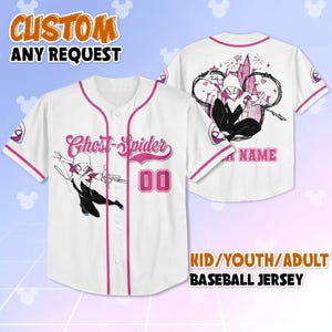 May include: White baseball jersey with pink trim and a Ghost-Spider graphic. The front features the text "Ghost-Spider" and the number "00". The back has a Ghost-Spider design and space for a name. The jersey is available in kid, youth, and adult sizes.