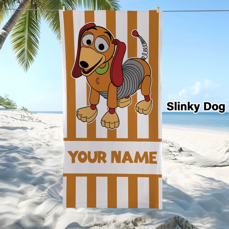 May include: A rectangular beach towel featuring a vertical orange and white striped pattern. The centre displays a cartoon Slinky Dog character with a brown body, red ears, and a silver spring midsection. The text YOUR NAME appears in orange.