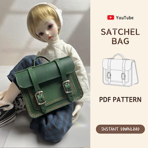 May include: A green satchel bag with silver buckles and a handle. The bag is shown with a doll wearing a white shirt and blue plaid pants. The text "SATCHEL BAG" and "PDF PATTERN" are visible.