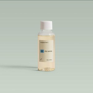 May include: A clear glass bottle with a white cap, containing a light yellow liquid. The label reads "Tessence No. 2" and "ritz sense" with a blue square graphic. The bottle contains 50ml / 1.69 fl oz.