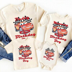 May include: Cream-colored t-shirts and a onesie featuring a red cartoon race car with the text "Daddy of the Birthday", "Mommy of the Birthday Boy", "Sister of the Birthday Boy", and "Name Birthday Boy".